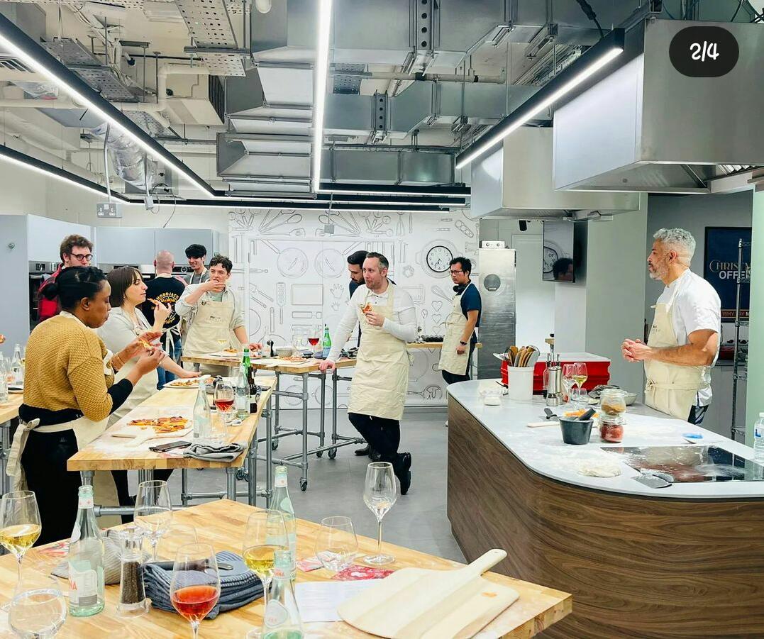 Students learning pizza making in a professional kitchen